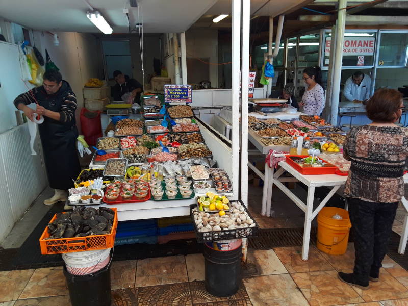 Local people sample food at the seafood market at the waterfront in Coquimbo.