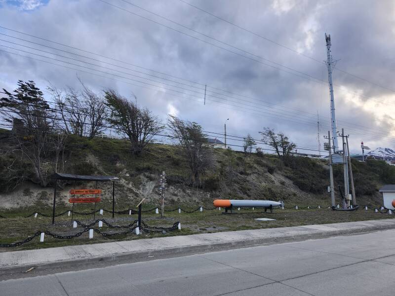 Torpedo, anchor, and signpost along the waterfront road.