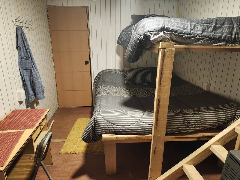 Interior of my room: beds, desk, and door to bathroom.