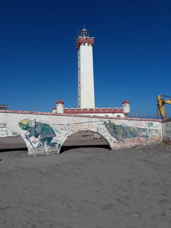 El Faro and broken walls, at the beach in La Serena, Chile.
