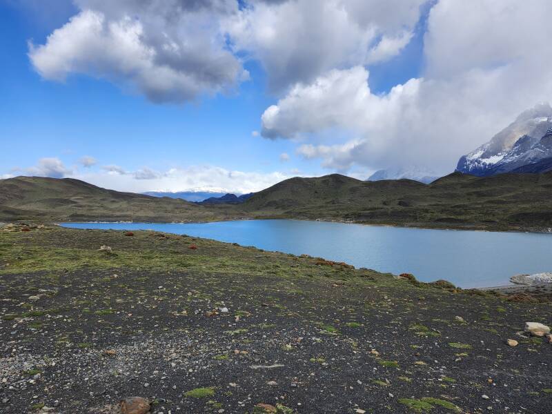 Laguna Largo in the foreground; Cerro Ferrier in the distance, cloud-covered Paine Grande, and Cuernos del Paine.