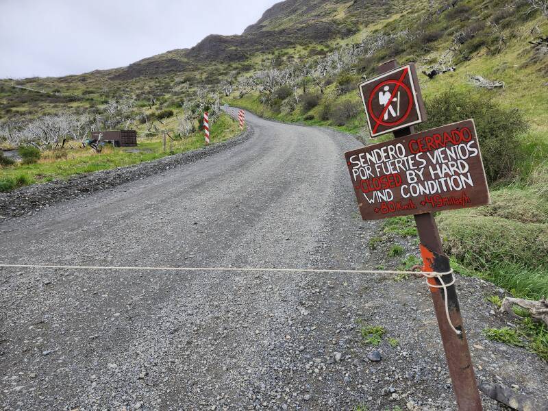 Sign saying that the area is closed due to high winds, sustained above 80 km/h.