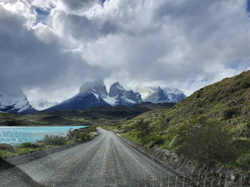 East end of Lago Pehoe, mountain peaks and dramatic clouds in the distance.