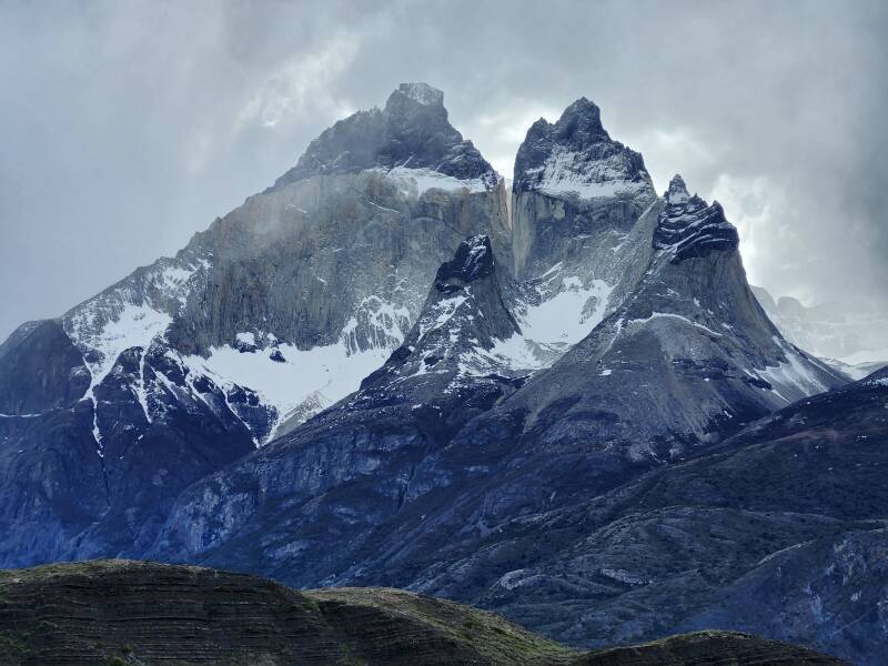 Wispy tendrils of clouds swirling around Cuernos del Paine.