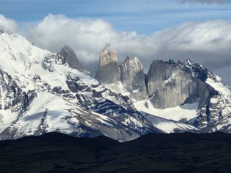 Mountain peaks and stone towers at Torres del Paine National Park.