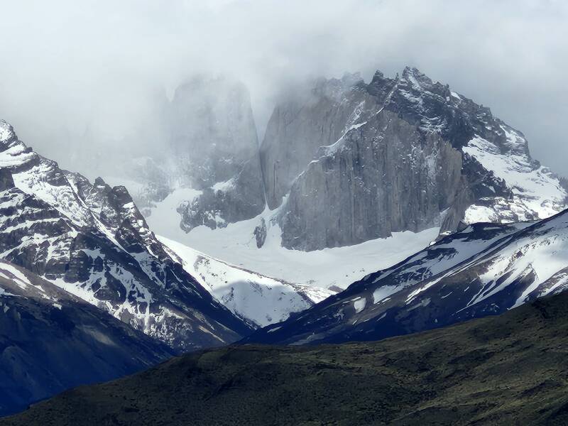 Left to right: Clouds obscuring Torre del Paine Sur, Torre del Paine Central, Torre del Paine Norte, and Cerro Nido de Condor.  10× digital zoom.