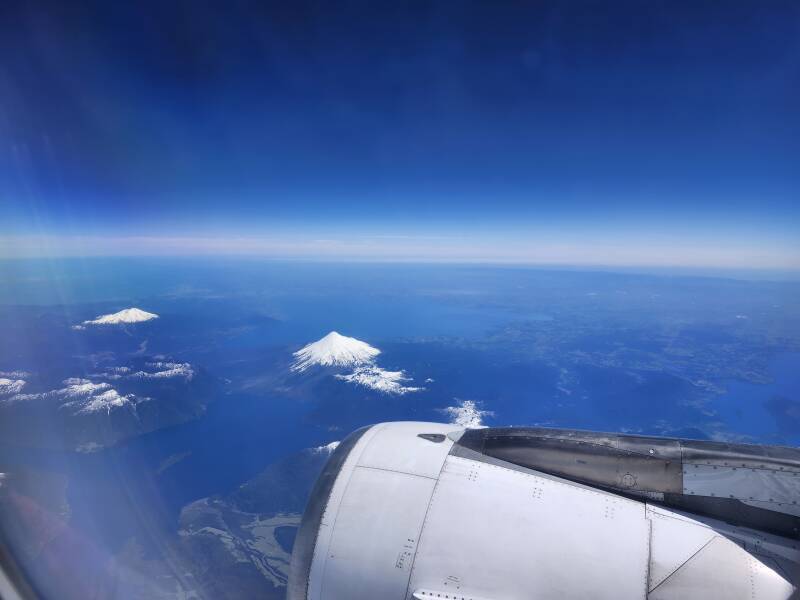 Isolated snow-covered conical volcanos.