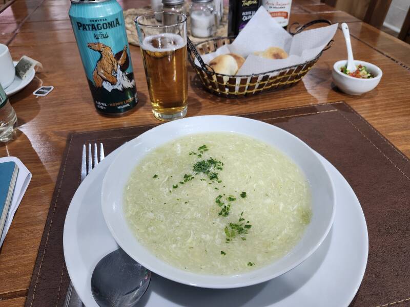 Patagonia Austral hoppy lager beer, egg-lemon soup, bread rolls, and pebre, the Chilean version of pico de gallo.