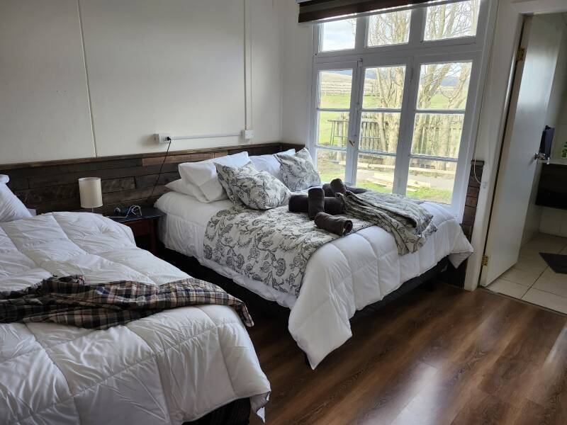 Room in Riverline Lodge — two double beds and a large window.