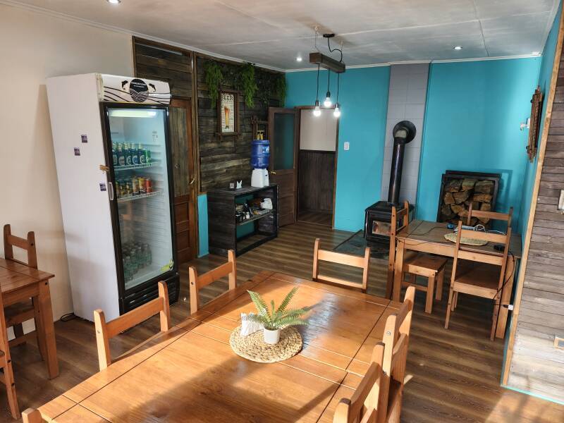 Dining room with drinks cooler, water cooler, and wood stove.