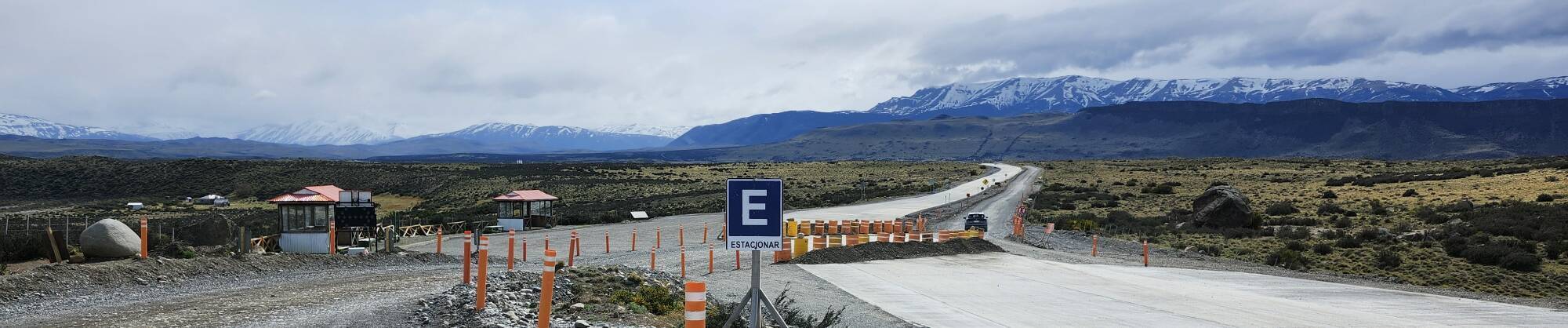 The road into Torres del Paine National Park, snow-covered mountains in the distance.