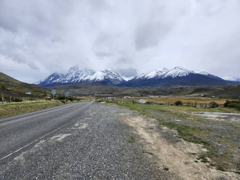 Approaching the park entrance, settlement of Amarga directly ahead, the mountains mostly invisible in low clouds.