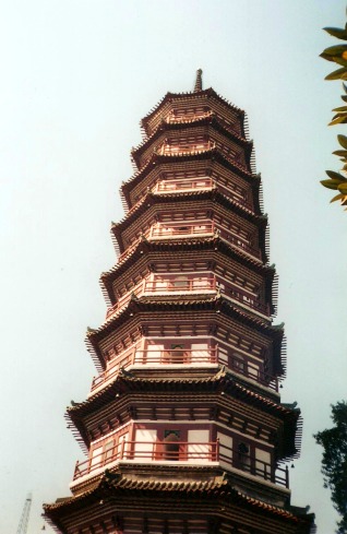 Tall red and white pagoda at a Buddhist temple in China.