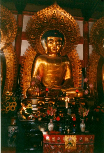 Large gold statue inside a Buddhist temple in China.