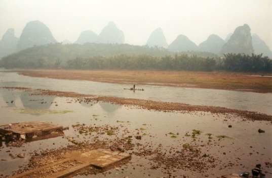 A cormorant fishman on a small boat on the Li River passing through Yangshuo in China.