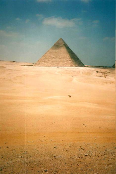 Looking back to the Great Pyramids of Giza from out in the desert.