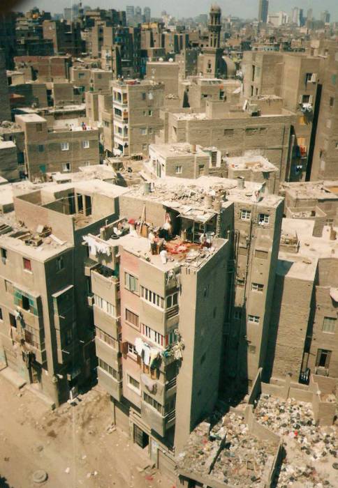 View from the minaret of the Ibn Tulum Mosque in Cairo.  A large pool of blood is visible on the roof on an apartment building, where a cow has been ritually slaughtered.