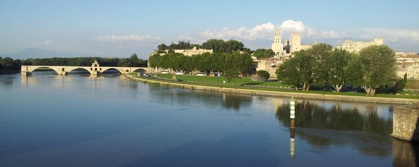 The Rhône river at Avignon, the Pont d'Avignon, the Palais des Papes or Palace of the Popes, the city walls of Avignon, and Mont Ventoux in the distance.