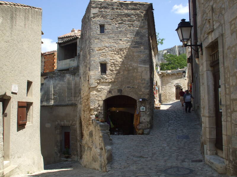 A street splits to lead both uphill and down in Les Baux-de-Provence in southern France.