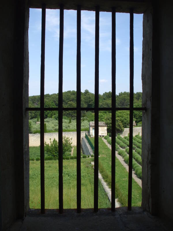 View of the lavender and other gardens from a barred window of the Maison de Santé St-Paul in St-Rémy-de-Provence.