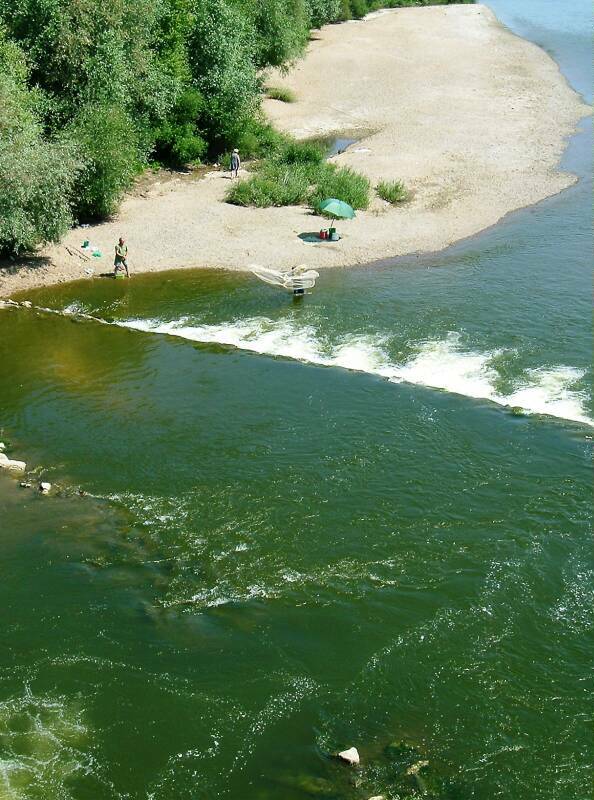 Looking down from the high canal bridge at Guétin at fishermen in the Allier River.