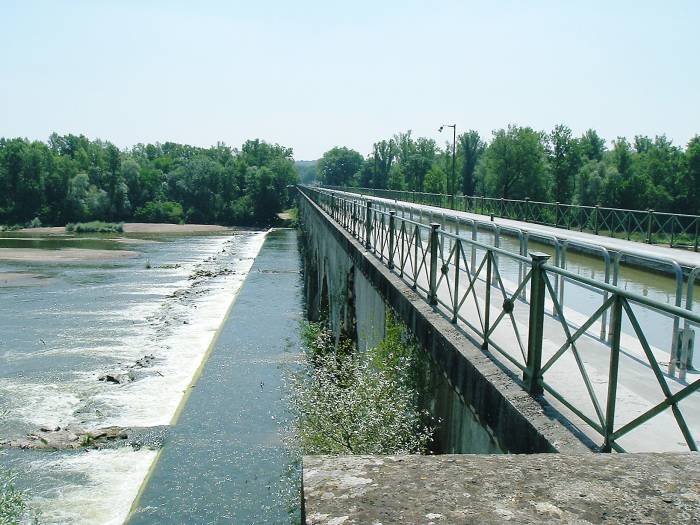 The side of a canal bridge over a river.