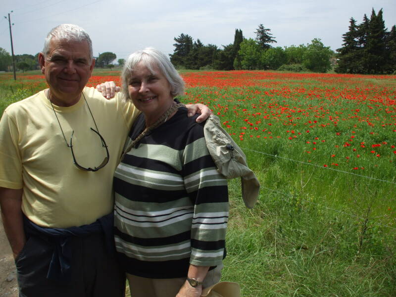 ALT: Larry and Shirley Gaudreau at a field of red poppies at Port Cassafières.