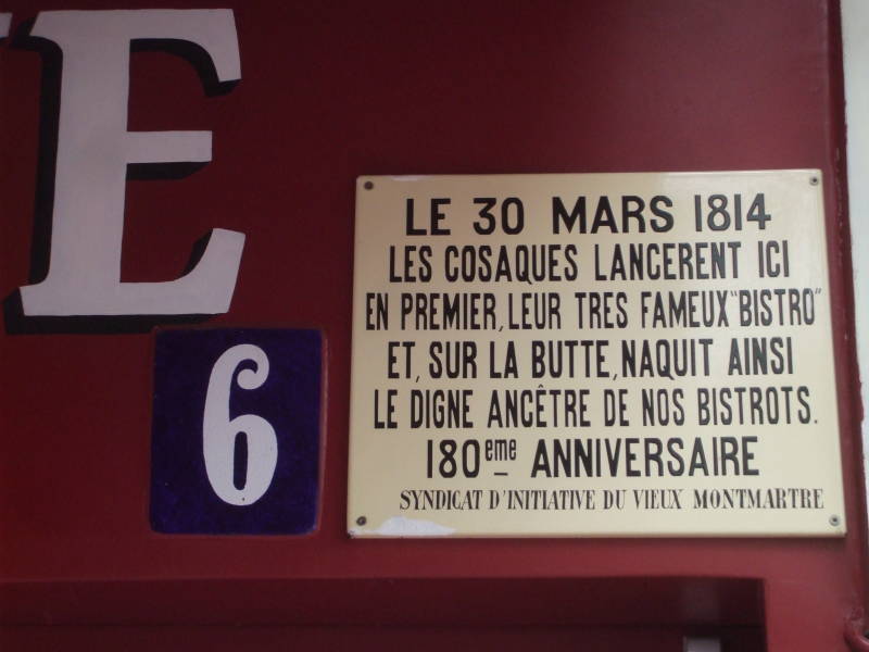 Sign at Café Madelaine on Place du Tertre on Montmartre in Paris, explaining there is where 'bistro' was first used.