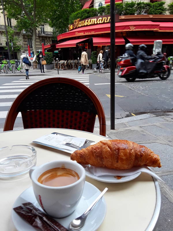 Cafe and croissant while sitting at Le Mistral bar-brasserie and tabac near Saint-Lazare in Paris.