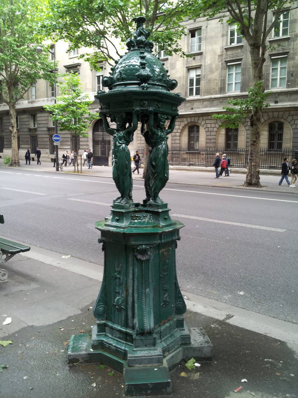 Dragon statues at the fountain at Place Saint-Michel near the Seine River through Paris.