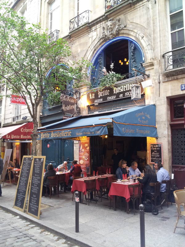 Café near Place Saint-Michel near the Seine River through Paris.