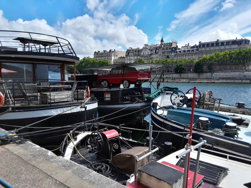 Residential boats along the Seine River through Paris.