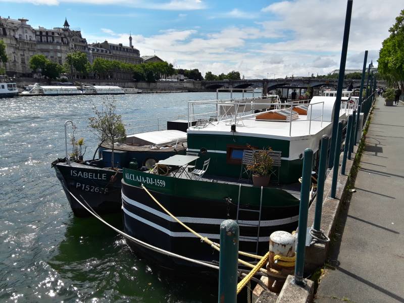 Residential boats along the Seine River through Paris.