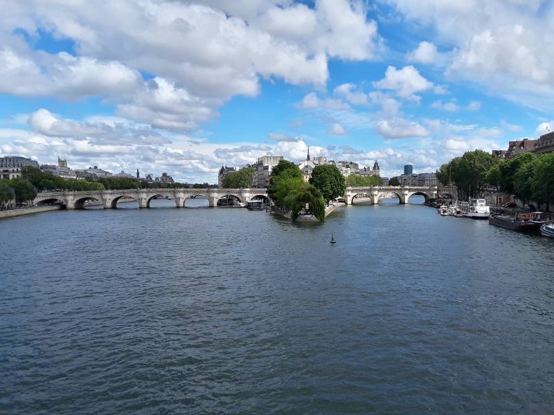 Crossing Pont des Arts or Passerelle des Arts across the Seine River through Paris.