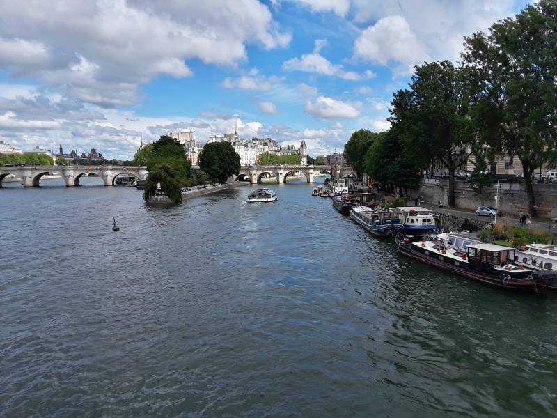 Crossing Pont des Arts or Passerelle des Arts across the Seine River through Paris.