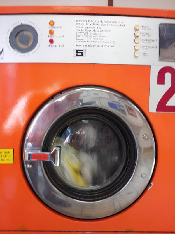 Washing machine in a lavomat or laverie in Avignon.