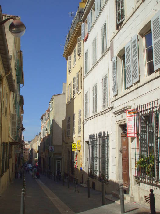 Small businesses along Rue des Petites Maries in Marseille.