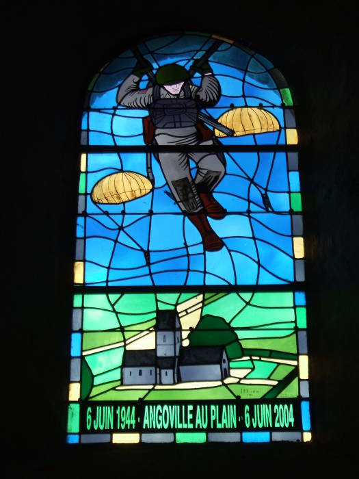 Stained glass window commemorating D-Day in the church at Angoville au Plain, in Normandy.  U.S. paratroopers above the church, '6 Juin 1944 - Angoville Au Plain - 6 Juin 2004' below.