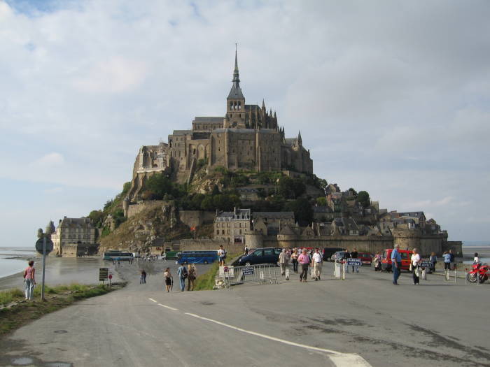 Looking up at the fortress and cathedral of Mont Saint-Michel from the causeway.