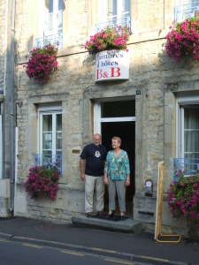 Monsieur and Madame Berot standing in the doorway of their guesthouse in Sainte Mere Eglise, in Normandy.