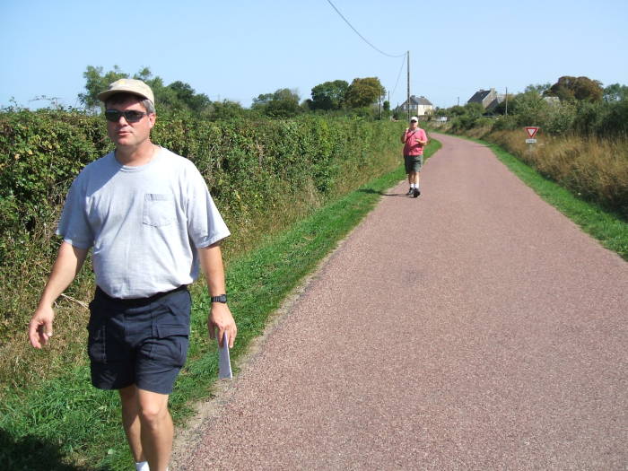 Tim and Jeff walking past blackberry hedges from Utah Beach to Sainte-Mère-Église.
