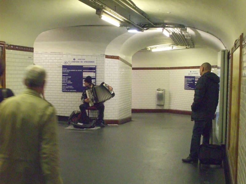 Musician in Paris Métro station tunnel.