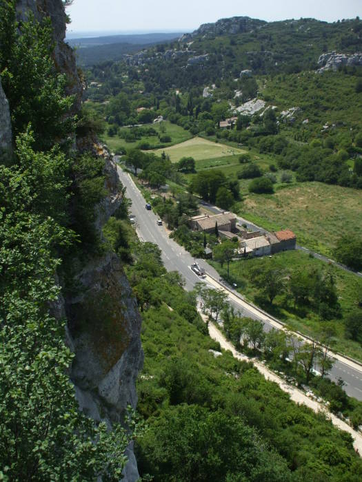 A road approaches the rocky Les Baux-de-Provence.