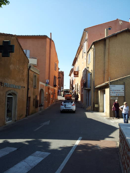 A small two-lane road runs through Roussillon.