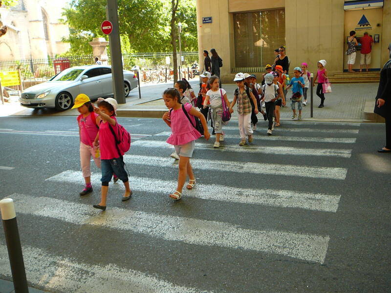 French school children cross a street in Avignon.