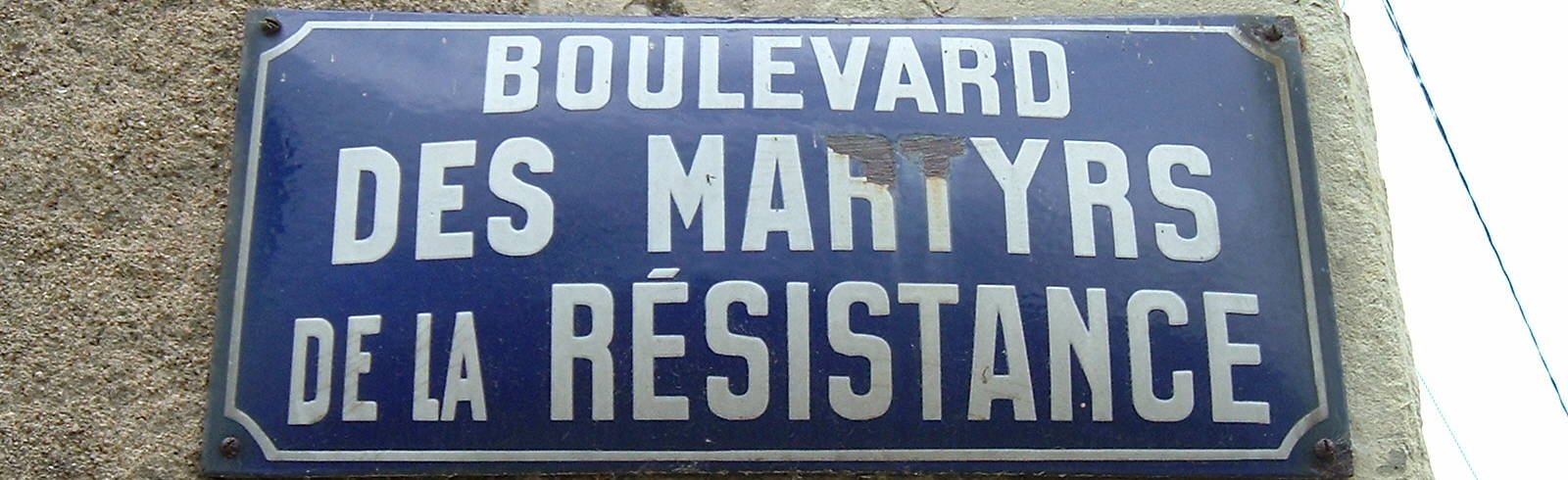 Street sign marking the Boulevard des Martyrs de la Résistance in Montreiul-Bailey in the western Loire Valley.