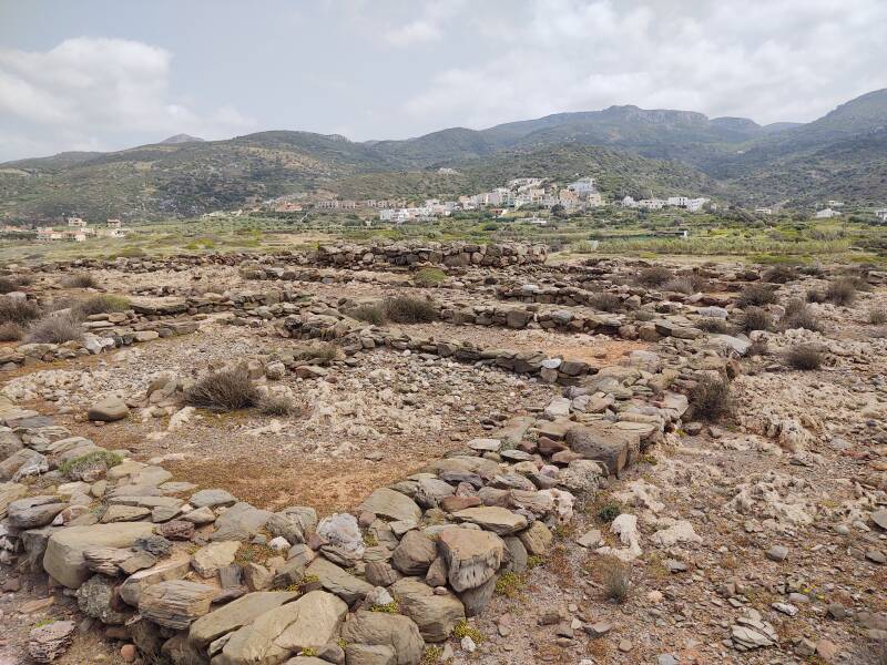 View south from the Minoan settlement and cemetery at Agia Fotia. The village of Agia Fotia with mountains behind it.