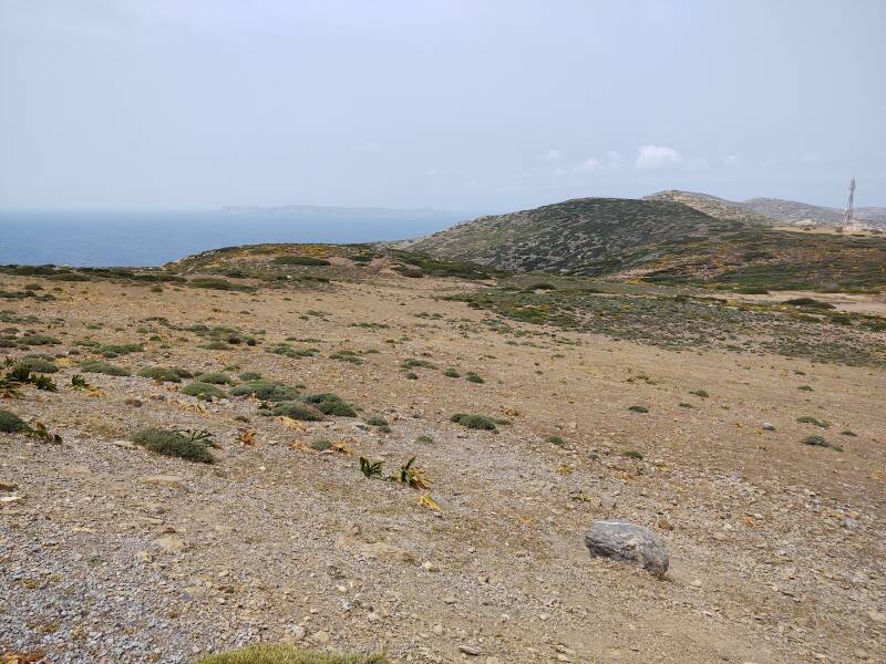 View from road west of Itanos, looking back to the northeast and out to sea, past a VHF/UHF/microwave relay station and over the tip of the Itanos peninsula in the distance.