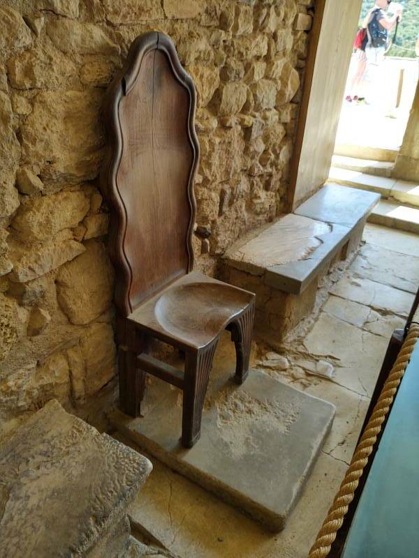 Replica wooden throne at 'Throne Room' at prehistoric site of Knossos, outside Heraklion in Crete.