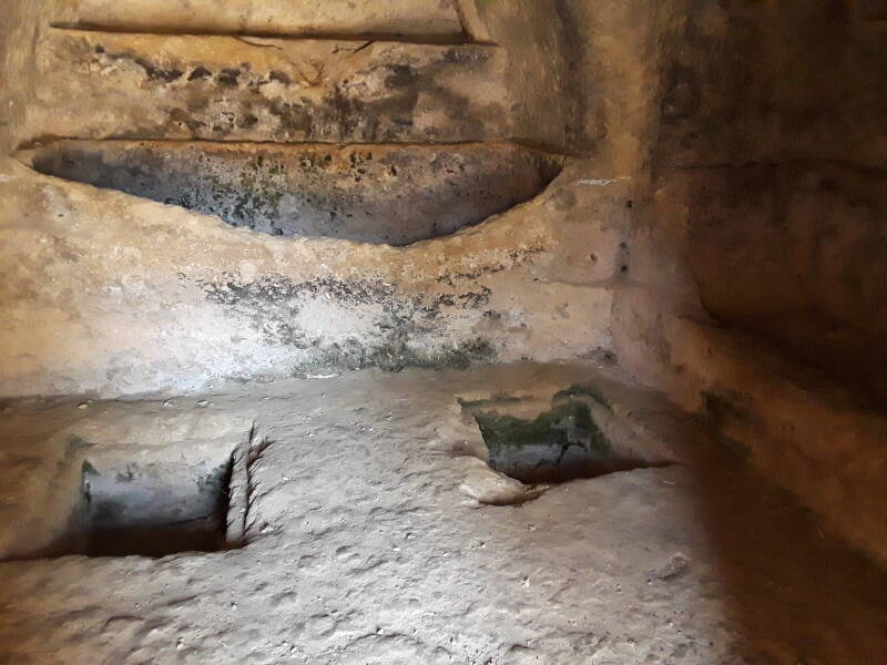 Two cyst graves and center niche grave in Roman-era rock-carved tomb at Necropolis Siderospilia near the Rizinia akropolis.